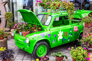 Flowers composition with green retro car