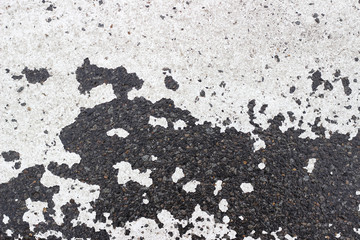 Asphalt pavement sign marking crosswalk white paint wet old surface texture detail