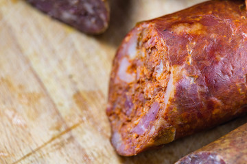 Detail of tasty homemade sausage on wood background