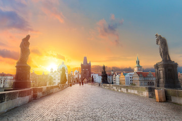 Charles Bridge Karluv Most and Old Town Tower at amazing sunrise with sky and clouds in Prague, Czech Republic.