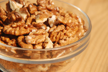 walnuts in bowl on wooden table
