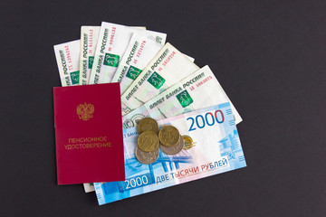 Pension certificate of Russia and banknotes, rubles. Pension reform in  Russian Federation. Text in Russian: 