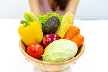 Young beautiful woman take care her health by eating salad and fruit instead of eating fat and calories
