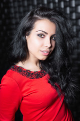 Playful young woman in red dress