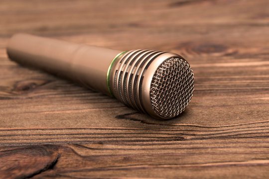 microphone on a wooden table background. music, singing, singing.