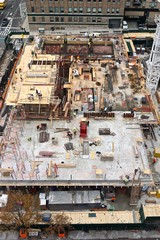 Aerial view of men and materials during the construction of a 42-story high-rise apartment building in midtown Manhattan, New York City.