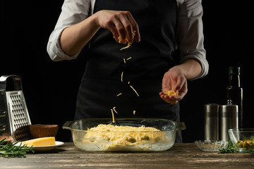 The chef prepares focaccia bread or pizza with olives, butter, cheese and rosemary greens. Rubs...