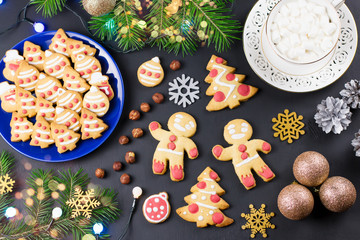 Tasty Christmas cookies, Christmas tree, decorations on black background. Christmas cooking concept