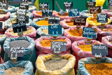 sacks with different spices for sale in French food market
