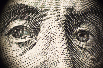 Enlarged fragment of  portrait of President Franklin on  banknote of 100 US dollars.