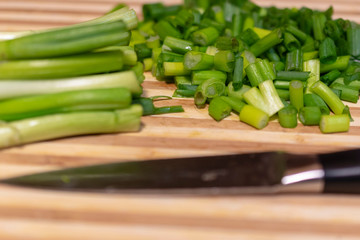 green onions on a wooden board
