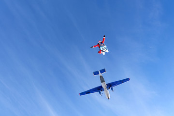 Fototapeta na wymiar Christmas skydiving. Santa Claus and little girl are in the sky.