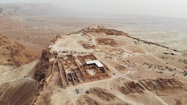 flying over Masada fortress area Southern District of Israel Dead Sea area Southern District of Israel. Ancient Jewish fortress of Roman Empire on top of a rock in Judean desert. view from the air