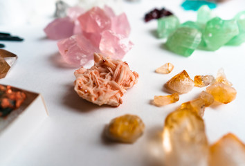 Collection of beautiful precious stones on white table.