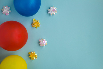 Colorful balloons and confetti on the blue background.Top view.Copy space.