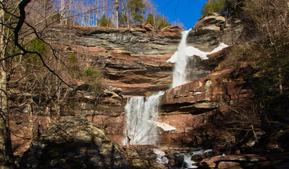 Kaaterskill Falls in the Catskill Mountains in New York on a Spring day with a little remaining snow.