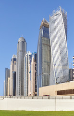 Naklejka premium Dubai modern skyscrapers against the blue sky, United Arab Emirates.