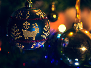 Christmas toy hanging on the tree in the dim light