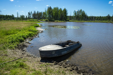 Boat on river at beautiful summer day.