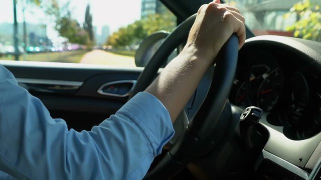 Woman driving car in reverse gear attentive driver looking for free parking spot