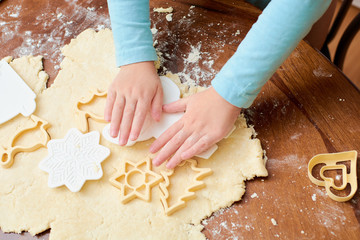 the child makes cookies from flour on the table