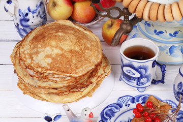Still life with pancakes, apples, cottage cheese and viburnum. Pancake week