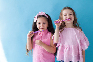 two beautiful small girls girlfriend sister in pink clothes