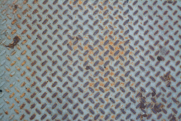 Texture of old and rusted metallic diamond plate. Metal floor plate.