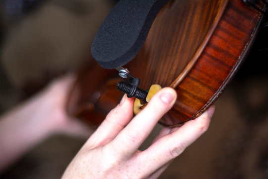 Violin girl setting up violin's brodge