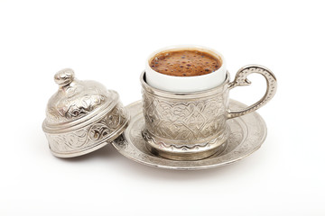 Turkish coffee in traditional silver cup on isolated white background