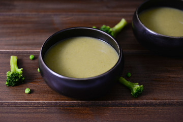 green vegetables pure soup with broccoli green pea and Dwarf cabbage on brown rustic wooden table 