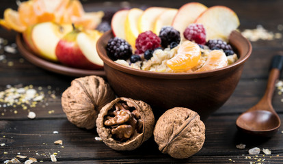 oatmeal with fruit on a wooden background