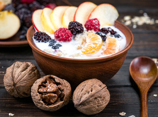 oatmeal with fruit on a wooden background