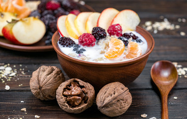 oatmeal with fruit on a wooden background