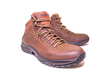 Brown winter boots with genuine leather laces on a white isolated background