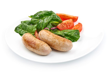 Fried Sausages from pork mince with spinach and tomatoes, close-up, isolated on a white background