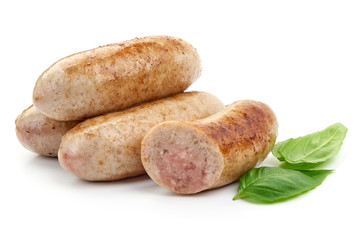 Grilled Munich Sausages with basil leaf, close-up, isolated on a white background