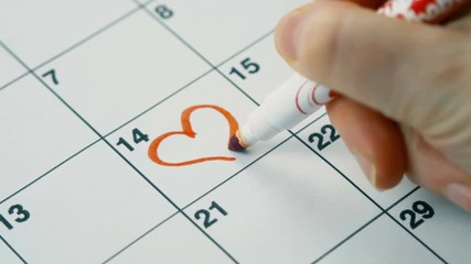 Record with a red marker on the calendar to Valentine's Day holiday. Close up 4k footage. - Powered by Adobe