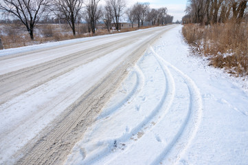 Tire track in the snow to the horizon