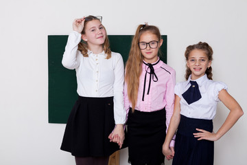 three girls in glasses at the Blackboard in a class lesson