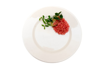 DeliciousDelicious citrus caviar on a white plate dec citrus caviar on a white plate decorated with a green sprig of citrus plants, Microcitrus australasica, Australian finger lime, close-up, isolated