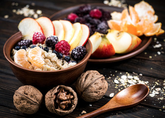 oatmeal with fruit on a wooden background