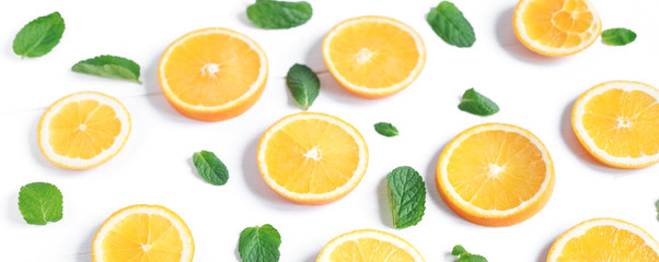 Fototapeta na wymiar Fresh orange slices on a light background. Background with orange and mint. Beautiful photo with citrus. Vitamin C. Orange and Fresh Mint Pattern