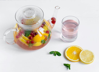 Fruit tea with orange, lemon and cranberries. Teapot with fruit orange, lemon, cranberry, mint. Tea for colds. Vitamin C Tea. Cold tea