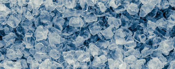 Pieces of crushed ice cubes on black background.