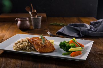 Salmon with vegetables on plate