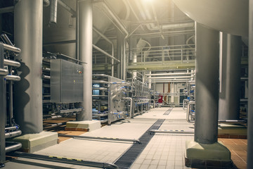 Steel pipes and storage reservoirs for beer fermentation of modern brewery factory as abstract industrial background