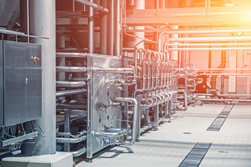 Steel pipes and storage reservoirs for beer fermentation of modern brewery factory as abstract industrial background