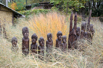 Brown wooden totems in dry grass