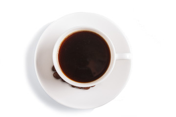 a cup of coffee with coffee beans on a plate, isolated on white. top view.